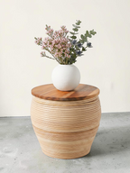 AYOMI handmade bamboo coffee table with a natural teak wood top, featuring a round vase with flowers on top.