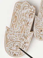 AYOMI hand-carved wooden Hamsa incense holder with white painted eye detail and natural wood finish