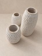 AYOMI set of three white whitewashed balsa wood vases with hand-carved organic textures for dry floral arrangements.