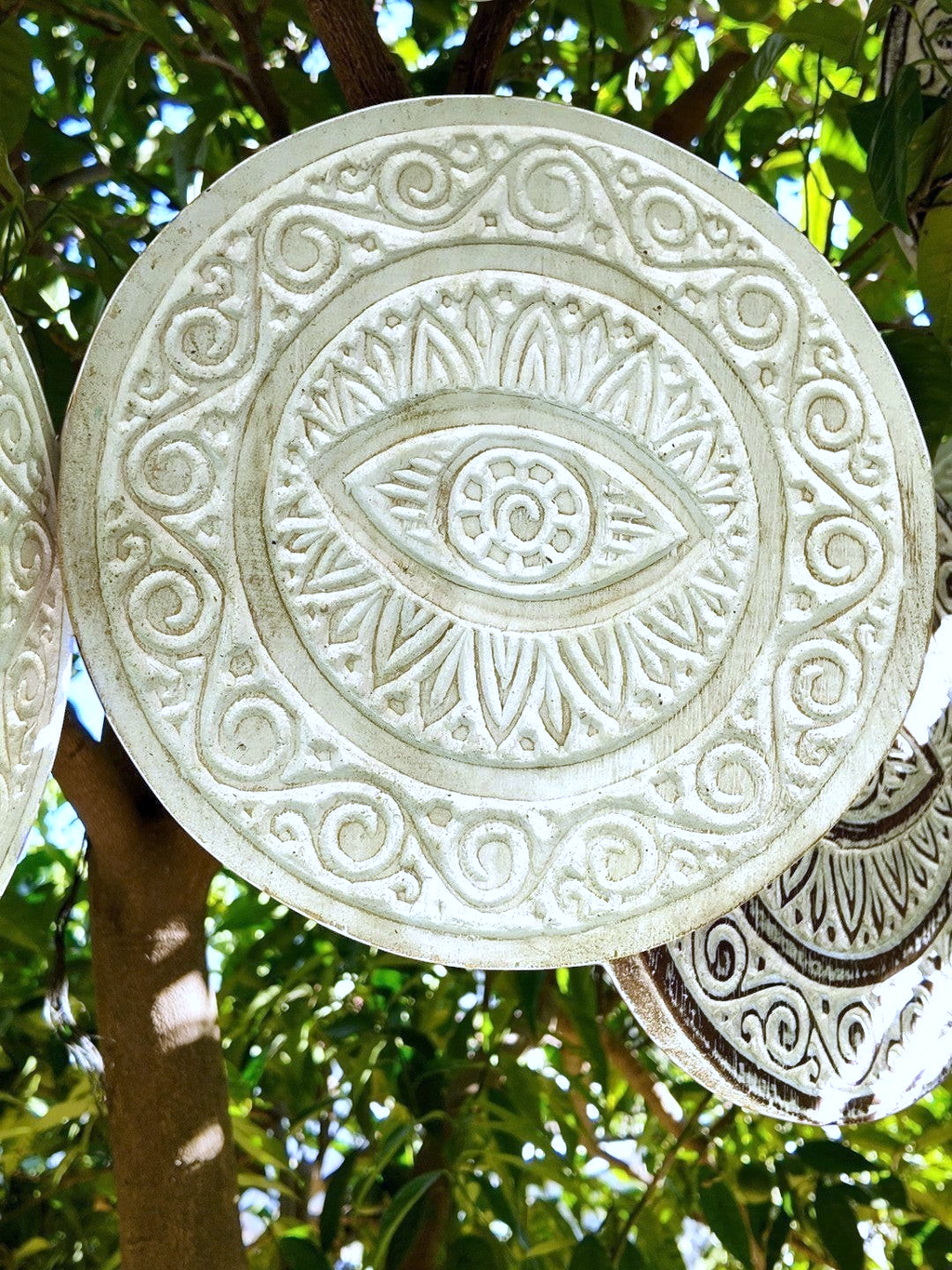AYOMI white hand-carved solid wood wall plate featuring an intricate evil eye nazar motif and decorative patterns.