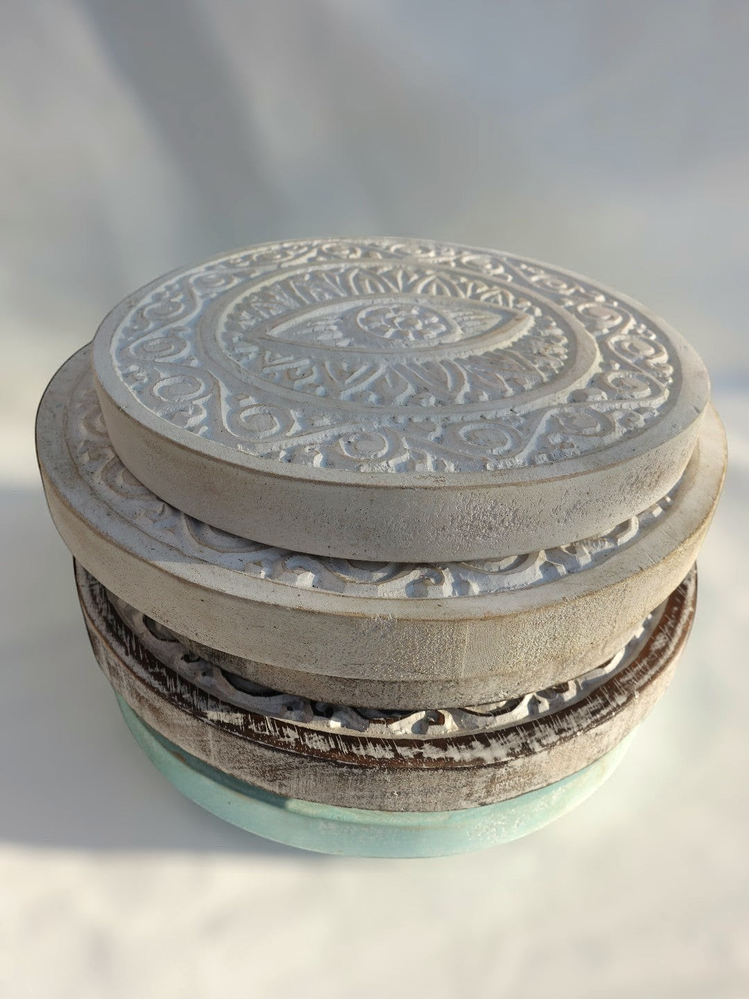 AYOMI set of two white hand-carved solid wood wall plates featuring intricate evil eye motifs and rustic textures.