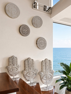 AYOMI set of two white hand-carved solid wood Nazar wall plates featuring intricate evil eye patterns.